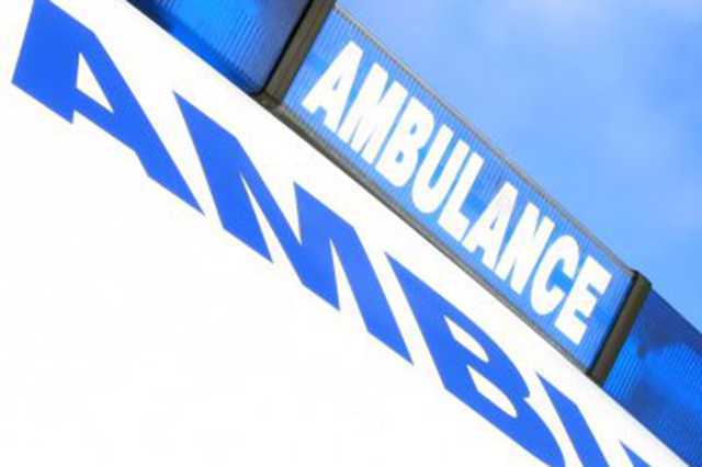 Cropped image of an ambulance showing the lettering  on the beacon