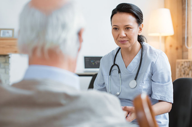 Image of a nurse speaking to an elderly patient